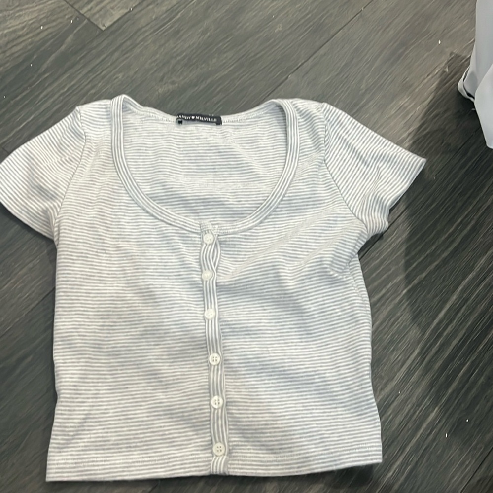 I’m selling a gray and white brandy Melville shirt with a rounded neck